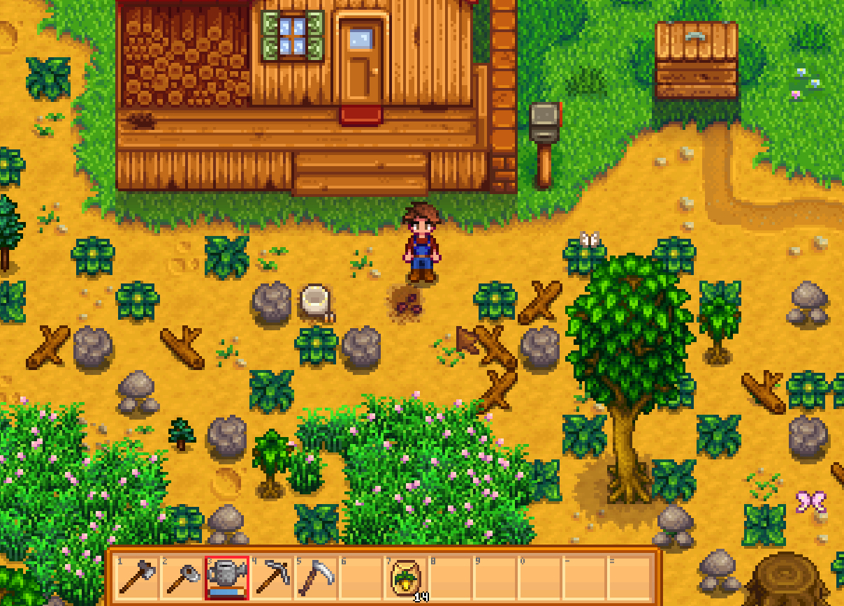 Stardew Valley farmhouse front with shipping bin mailbox and uncleared stones while watering can is selected