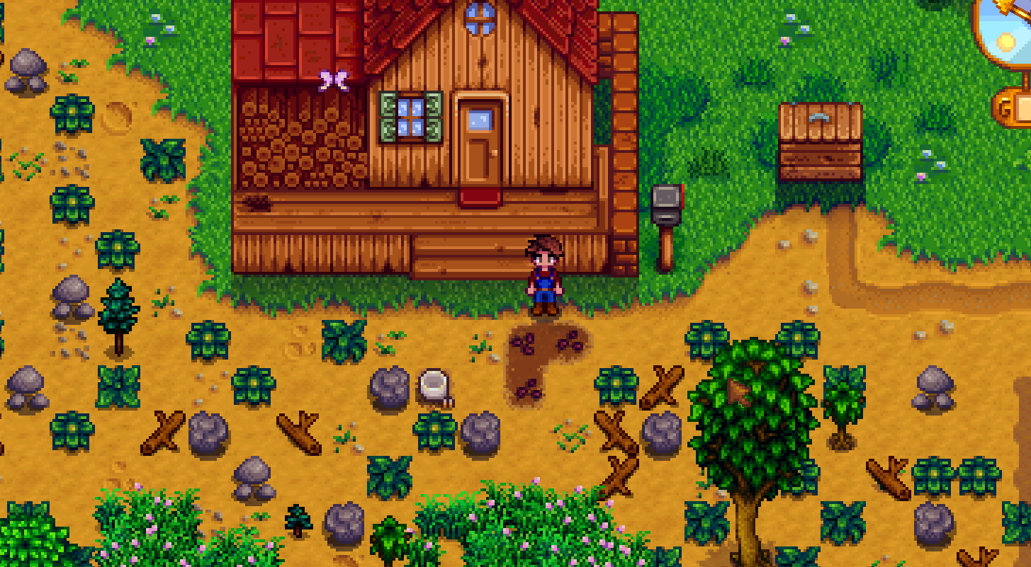 Stardew Valley tiny tilled seed patch in front of the farmhouse porch with debris still around it
