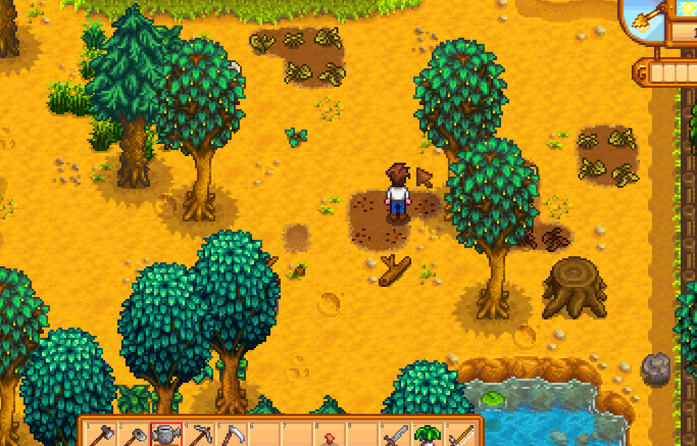 Stardew Valley farm with watering can selected near a small tilled crop patch